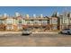Townhomes featuring wood decks, brick accents, and dedicated parking spaces at 1885 S Quebec Way # A16, Denver, CO 80231