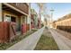 Exterior view of a townhouse with a walkway, wooden fence, and a balcony at 1885 S Quebec Way # A16, Denver, CO 80231