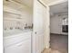 Laundry area featuring a modern washer and dryer with shelving for storage at 1885 S Quebec Way # A16, Denver, CO 80231