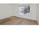 Living room featuring neutral carpet, white walls, and a bright window view at 1885 S Quebec Way # A16, Denver, CO 80231
