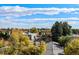 Aerial view showcasing surrounding neighborhood and city skyline at 1412 Pierce St, Lakewood, CO 80214