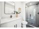 Clean bathroom featuring a modern vanity, sink and a glass-enclosed shower at 1412 Pierce St, Lakewood, CO 80214