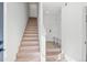 Bright entry with staircase, built-in bench, and light flooring at 1412 Pierce St, Lakewood, CO 80214