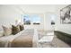 Sun-filled main bedroom featuring bright, oversized windows, neutral decor, and soft carpet at 1412 Pierce St, Lakewood, CO 80214