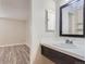 Clean bathroom with a dark vanity, sink, and open shelves at 4281 S Salida Way # 8, Aurora, CO 80013