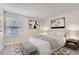 Inviting bedroom featuring a comfortable bed, modern artwork, and a cozy bench at 4281 S Salida Way # 8, Aurora, CO 80013