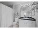 Well-lit bathroom with mirror, vanity, and shower with curtain at 12896 Ironstone Way # 203, Parker, CO 80134