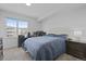 Bright bedroom featuring a large window, neutral carpet, and a comfortable queen-size bed with study area at 12896 Ironstone Way # 203, Parker, CO 80134