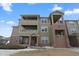 Charming exterior of the building featuring private balconies and manicured grounds at 12896 Ironstone Way # 203, Parker, CO 80134