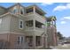 Well-maintained building exterior featuring multiple balconies and brick accents at 12896 Ironstone Way # 203, Parker, CO 80134