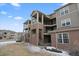 Well-kept condo building with brick accents and staircase to upper floors at 12896 Ironstone Way # 203, Parker, CO 80134