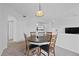 Bright dining room with table and seating for four; open concept and neutral paint at 12896 Ironstone Way # 203, Parker, CO 80134