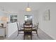 Bright dining room with table and seating for four; open to living space and balcony at 12896 Ironstone Way # 203, Parker, CO 80134