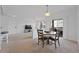 Bright dining room with table and seating for four; open concept to kitchen and living space at 12896 Ironstone Way # 203, Parker, CO 80134