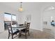 Bright dining room with table and seating for four; access to balcony and bedroom at 12896 Ironstone Way # 203, Parker, CO 80134