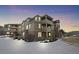 Beautiful multi-story condo building with brick accents and private balconies, shown during winter at 12896 Ironstone Way # 203, Parker, CO 80134