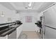 Bright kitchen featuring white cabinets, stainless steel appliances, and elegant black countertops at 12896 Ironstone Way # 203, Parker, CO 80134