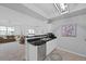 Bright kitchen featuring white cabinets, stainless steel appliances, and elegant black countertops at 12896 Ironstone Way # 203, Parker, CO 80134