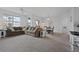 Open-concept living room with dining area, large sofa, and natural light from a large window at 12896 Ironstone Way # 203, Parker, CO 80134