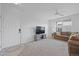 Bright living room with neutral carpet, ceiling fan, large window, and a comfortable sofa at 12896 Ironstone Way # 203, Parker, CO 80134