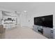 Bright, open living area featuring bar seating to the kitchen and a large TV stand at 12896 Ironstone Way # 203, Parker, CO 80134