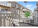 Private balcony with outdoor seating, offering a relaxing space to enjoy the views of the building at 7455 E Quincy Ave # 204, Denver, CO 80237