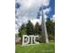 Metal DTC monument with towering spire in front of green lawn with trees and cloudy blue sky background at 7455 E Quincy Ave # 204, Denver, CO 80237