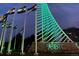 Nighttime view of the iconic DTC monument illuminated with vibrant green lights and Colorado flags at 7455 E Quincy Ave # 204, Denver, CO 80237