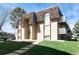 This exterior shows a two-story apartment building with a well-manicured lawn and a beautiful roof at 7455 E Quincy Ave # 204, Denver, CO 80237