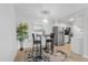 This kitchen features stainless steel appliances, a small table for eating, and wood-look floors at 7455 E Quincy Ave # 204, Denver, CO 80237