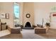 Inviting lobby with cozy seating area, a decorative fireplace, and a tall window offering natural light at 7455 E Quincy Ave # 204, Denver, CO 80237
