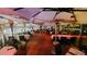 An outdoor dining area is shown at night, with multiple tables and chairs under a large canopy at 7455 E Quincy Ave # 204, Denver, CO 80237