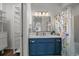 Bathroom boasts a blue vanity, white countertop and decorative floral curtain at 13023 Grant Cir # C, Thornton, CO 80241