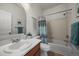 Well-lit bathroom featuring a shower-tub, tile flooring, and a decorative macrame wall hanging at 13023 Grant Cir # C, Thornton, CO 80241