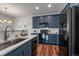 Kitchen showcases blue cabinets, white countertops, stainless steel sink and black appliances at 13023 Grant Cir # C, Thornton, CO 80241