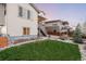 Lush backyard featuring a green lawn and a stone patio at 11100 Pastel Pt, Parker, CO 80134