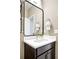 Stylish powder room featuring a modern vanity with a white countertop and a sleek black framed mirror at 11100 Pastel Pt, Parker, CO 80134