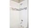Bathroom shower featuring modern chrome fixtures and a decorative gray mosaic accent at 11100 Pastel Pt, Parker, CO 80134