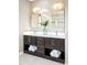 Bright bathroom with a double vanity with undermount sinks, undermount lighting, and decorative towels at 11100 Pastel Pt, Parker, CO 80134