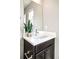 Powder room featuring a vessel sink, modern faucet, dark cabinet, and decorative greenery at 11100 Pastel Pt, Parker, CO 80134