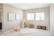 Neutral bedroom featuring carpeted floors, teepee, two windows, and two pieces of decorative artwork at 11100 Pastel Pt, Parker, CO 80134