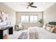 Bright primary bedroom with two large windows, stylish furnishings, and elegant decor at 11100 Pastel Pt, Parker, CO 80134