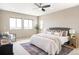 Bright primary bedroom with three large windows, stylish furnishings, and elegant decor at 11100 Pastel Pt, Parker, CO 80134
