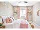Light-filled bedroom boasts soft decor, light walls, decorative artwork, and a large window with blush colored drapes at 11100 Pastel Pt, Parker, CO 80134