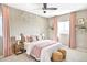 Light-filled bedroom boasts soft decor, light walls, decorative artwork, and large windows with blush colored drapes at 11100 Pastel Pt, Parker, CO 80134