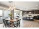 Open-concept dining room with hardwood floors, pendant lighting, and seamless access to the kitchen at 11100 Pastel Pt, Parker, CO 80134