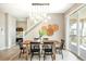 Elegant dining area with a wooden table, black chairs, modern light fixture, and access to an outdoor patio at 11100 Pastel Pt, Parker, CO 80134