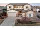 Inviting two-story home featuring a three-car garage, stone accents, and a well-manicured front yard at 11100 Pastel Pt, Parker, CO 80134
