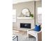 Living room featuring a modern fireplace, white armchair with a blue pillow, and natural light at 11100 Pastel Pt, Parker, CO 80134