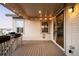 Inviting outdoor patio with string lights, sliding glass door, and wooden flooring at 11100 Pastel Pt, Parker, CO 80134